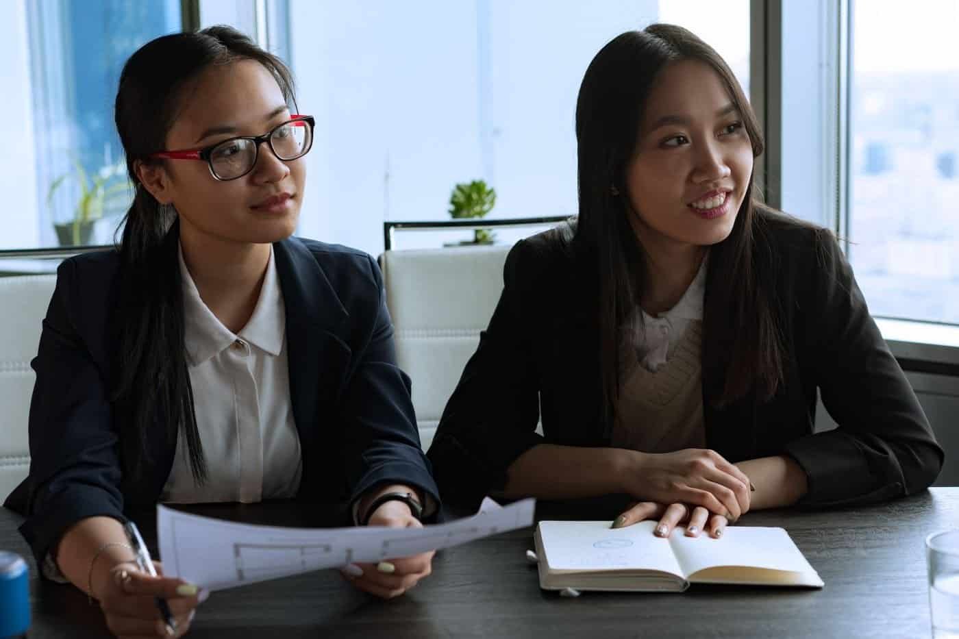 Two Asian businesswomen in a serious discussion in a Singapore office