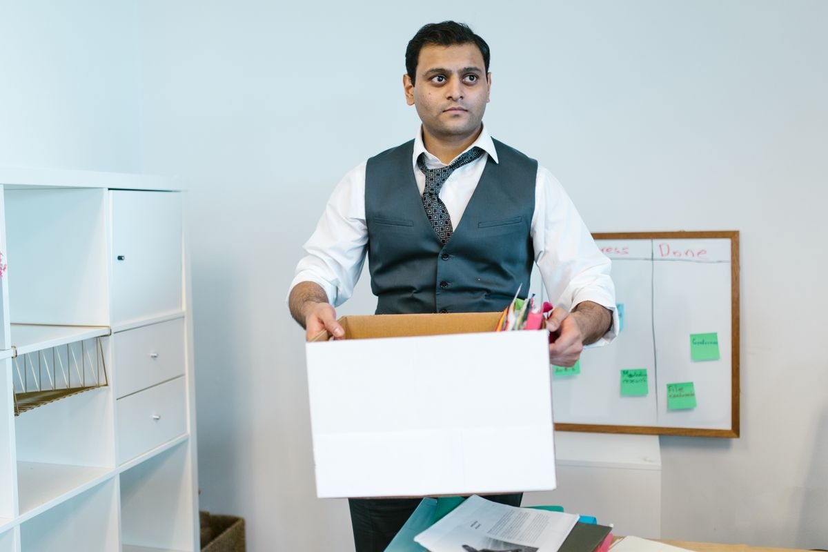 Employee handing a signed resignation letter to their manager in a Singapore office