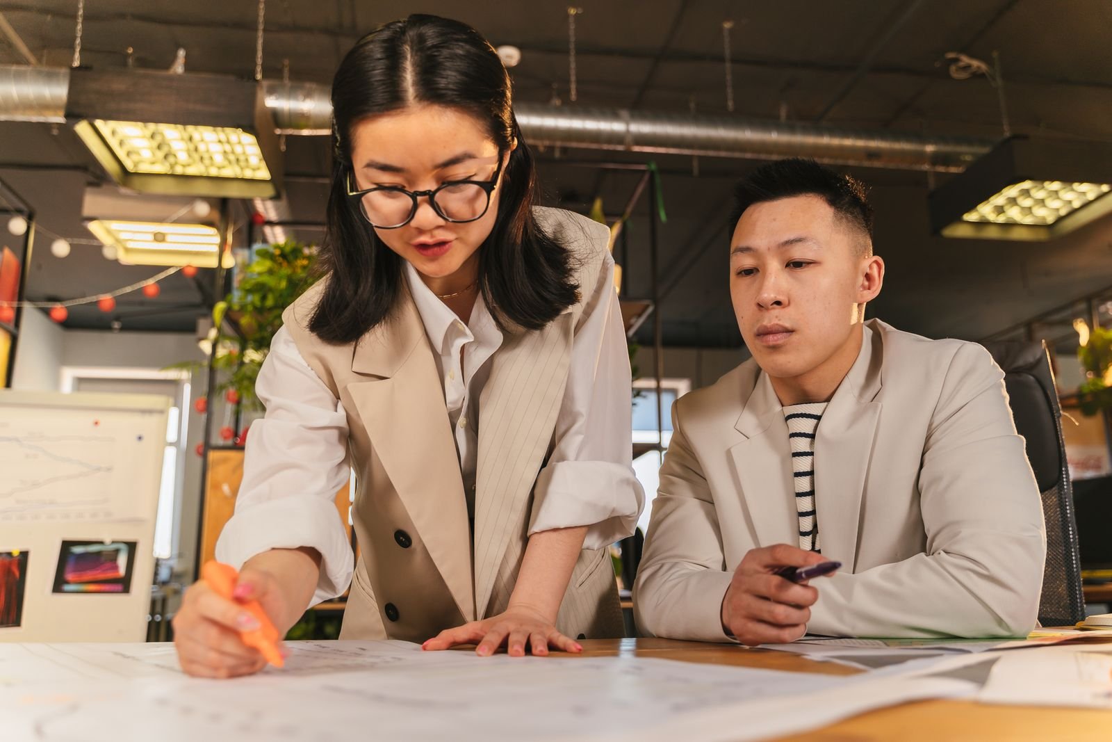 Employer and new employee reviewing probation period terms during onboarding in a Singapore office