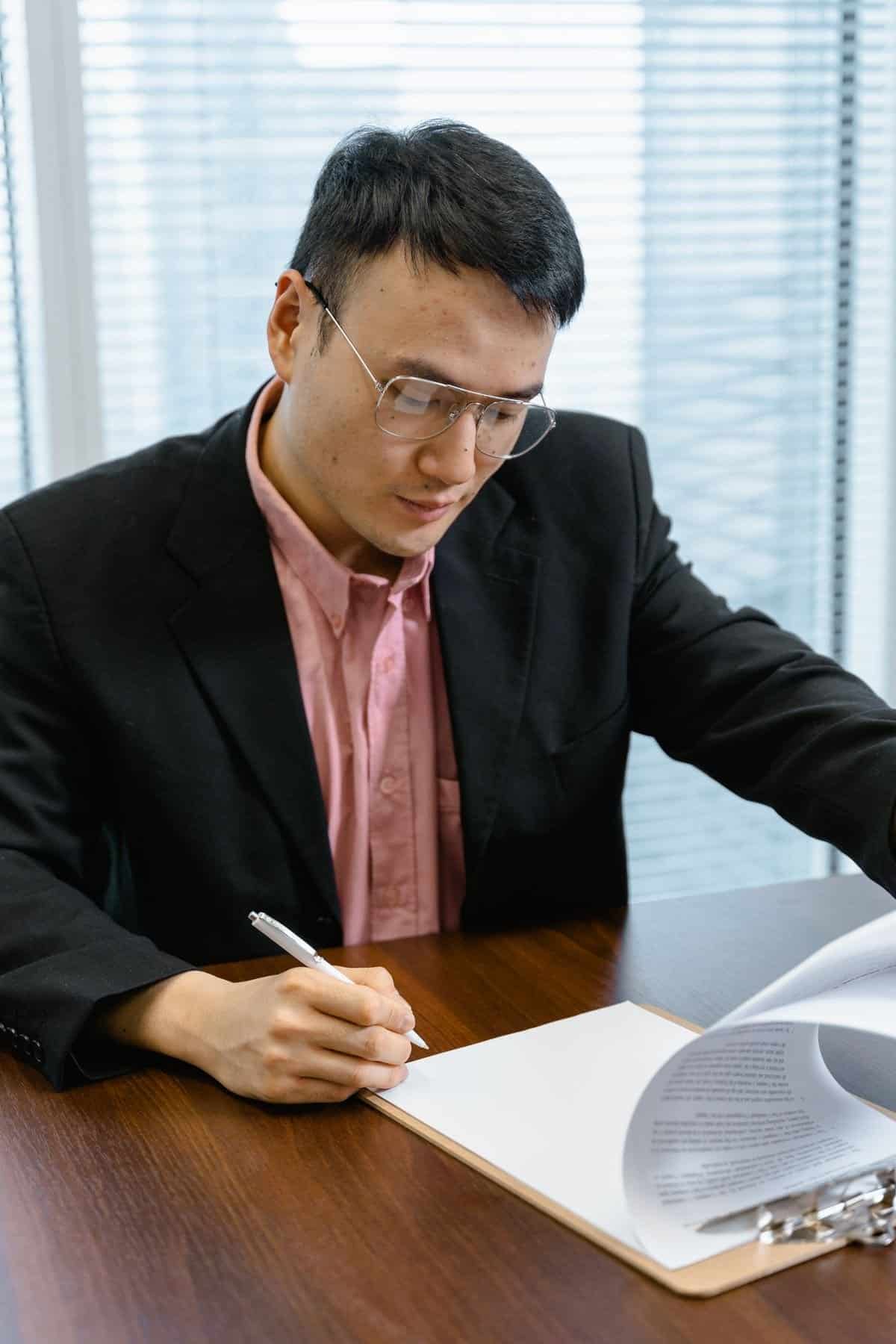 Employer reviewing a salary deduction record before signing off in Singapore