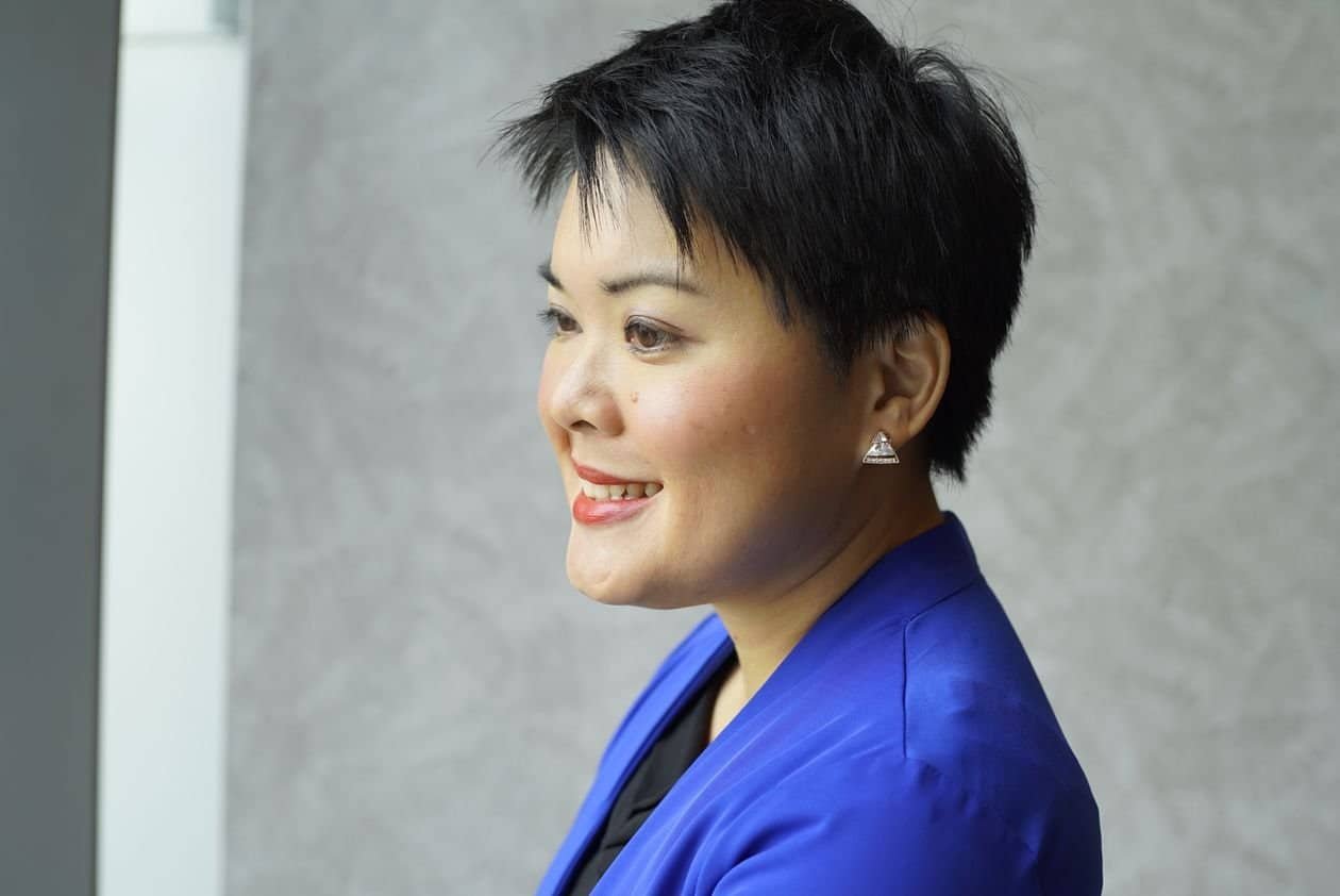 Senior Asian businesswoman in Singapore discussing retirement age and re-employment options