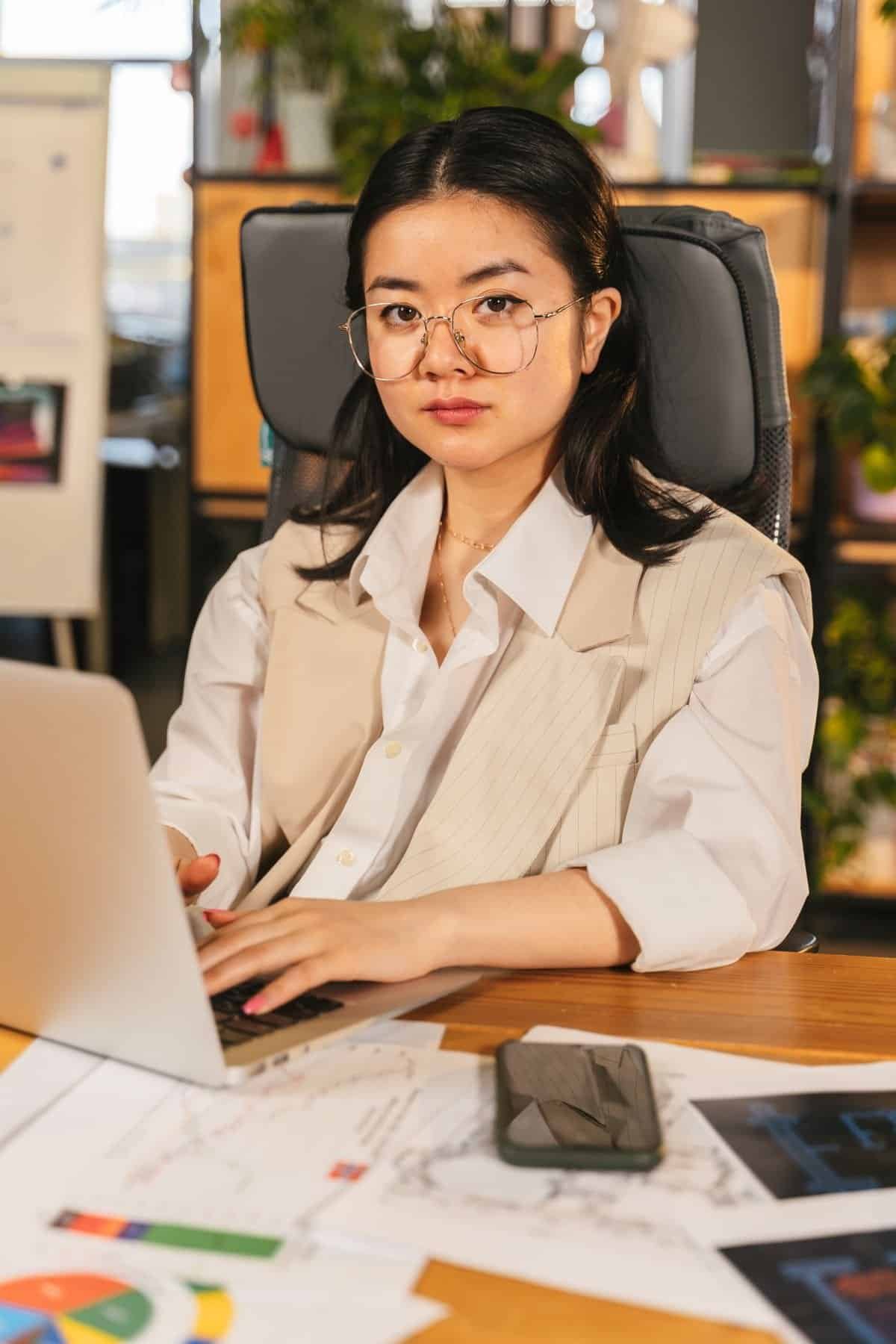 Asian professional woman working at a desk in an office